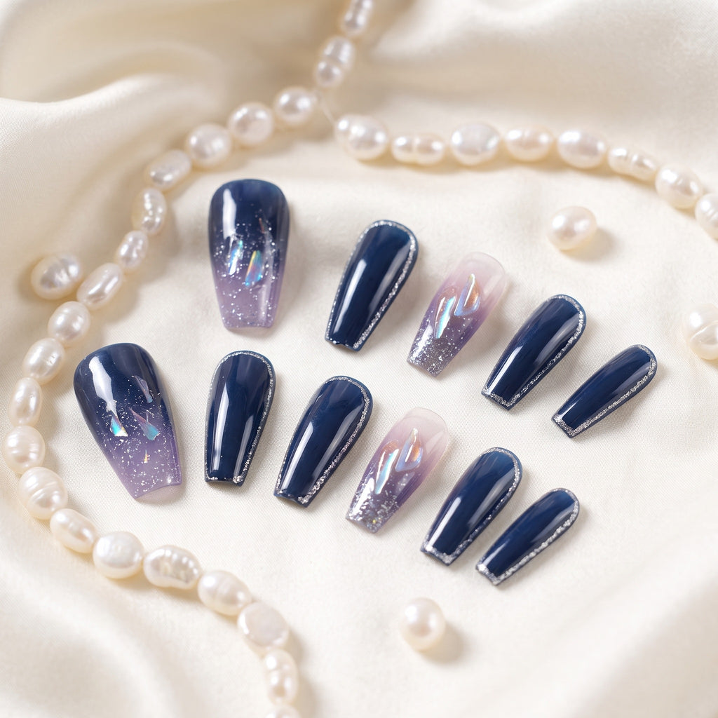 Navy blue press-on nails with silver glitter accents on ivory silk